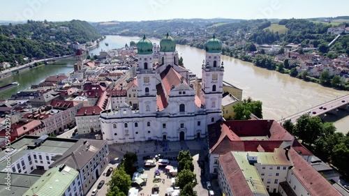 St. Stephen's Cathedral in Passau mid day with Danube and Inn joining in the background, peaceful German town, bright day