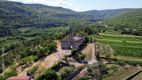 Wide reverse drone shot on the Holy Trinity Church in Slovenia, village of Hrastovlje, catholic church