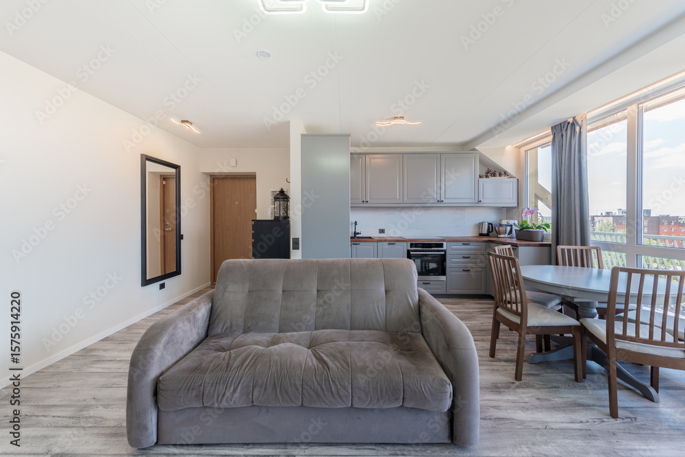 Fototapeta premium Modern Home Open Living Room With Sofas and Large Windows Overlooking City Scene