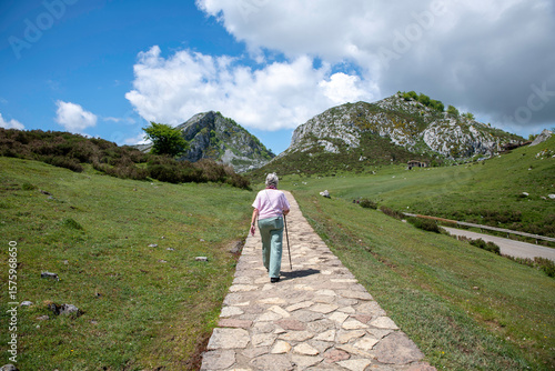 Senior Woman Hiking on Mountain Path to the picos the europa Surrounded by Scenic Landscape