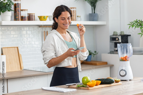 Fototapeta Influencer woman talking about nutrition to her followers while recording with s