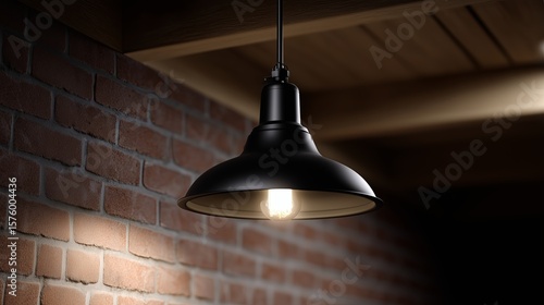 Elegant black pendant light illuminating rustic brick wall