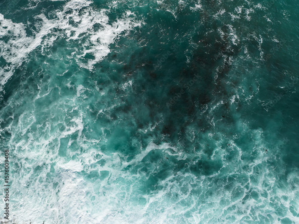 Aerial view of the ocean's surface, where turquoise waters clash with foamy white waves, creating a mesmerizing dance of light and shadow, San Diego, California, United States. Aerial view of the ocean's surface, where turquoise waters clash with foamy white waves, creating a mesmerizing dance of light and shadow, San Diego, California, United States.