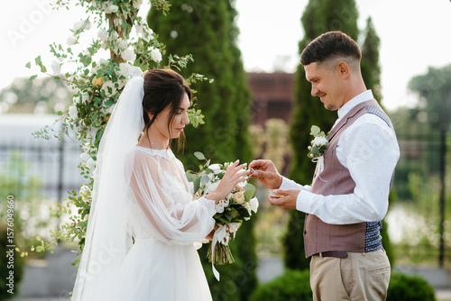wedding ceremony of a young couple in love on a green meadow