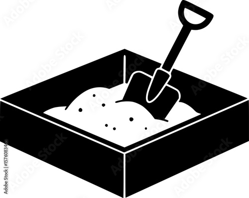 Black and white illustration of a sandbox with a shovel inside
