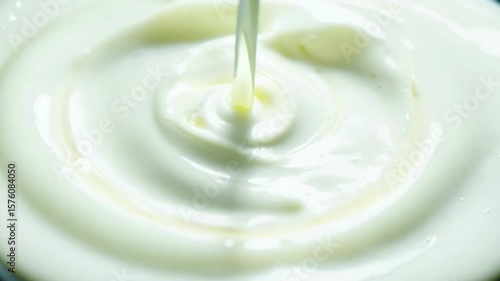 Wallpaper Mural Vibrant white liquid pours steadily into white circular container creating mesmerizing swirling patterns and ripple effects with smooth fluid motion and dynamic texture Torontodigital.ca