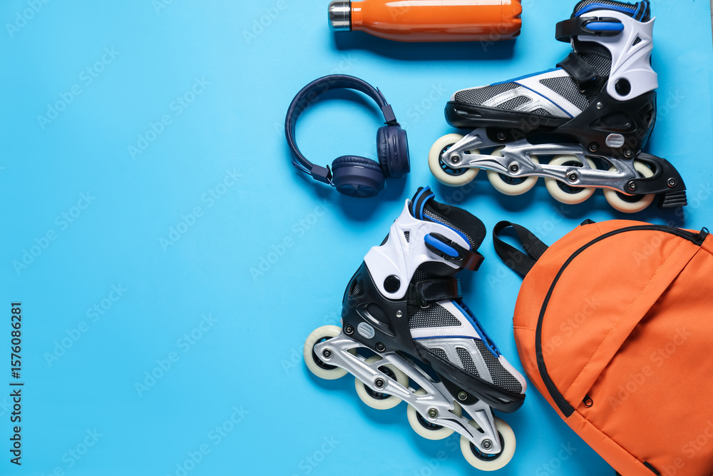 Obraz premium Flat lay composition with roller skates on blue background. Space for text
