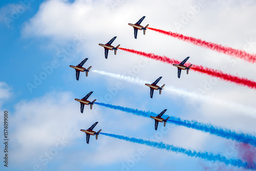 Aerobatic demonstration from the Patrouille de France flying in formation . The French Air and Space Force’s official display team performing precision maneuvers with jet aircraft.
