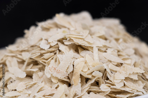 Poha or Flattened rice or Beaten rice on balck background..