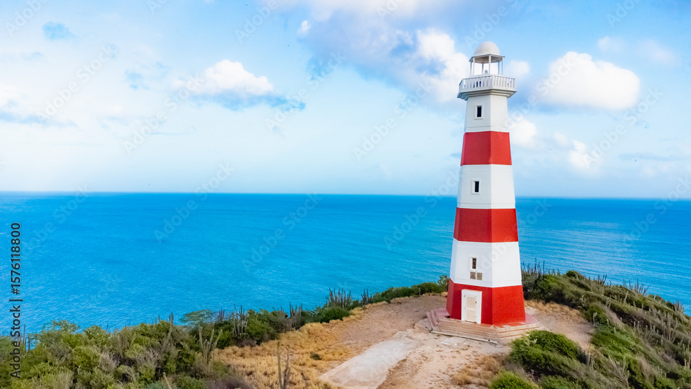 Red and White Lighthouse by the Ocean on a Sunny Day Red and White Lighthouse by the Ocean on a Sunny Day