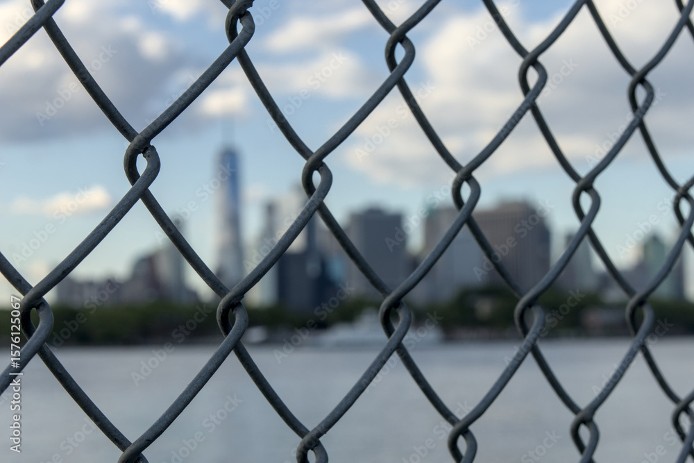downtown manhattan new york city skyline seen through metal chain link fence from red hook brooklyn nyc usa skyscrapers tall urban buildings waterfront east river harbor travel tourism jail lockup ny downtown manhattan new york city skyline seen through metal chain link fence from red hook brooklyn nyc usa skyscrapers tall urban buildings waterfront east river harbor travel tourism jail lockup ny