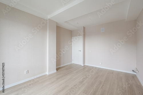 Wallpaper Mural bright, empty room with light wood flooring, beige walls, a white door, and white trim Torontodigital.ca