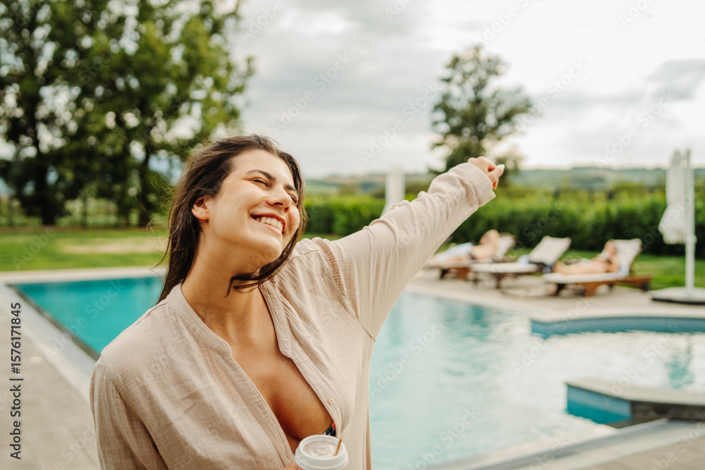 Young caucasian woman enjoying free time by the swimming pool Young caucasian woman enjoying free time by the swimming pool