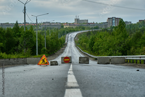 closed road with city in the background