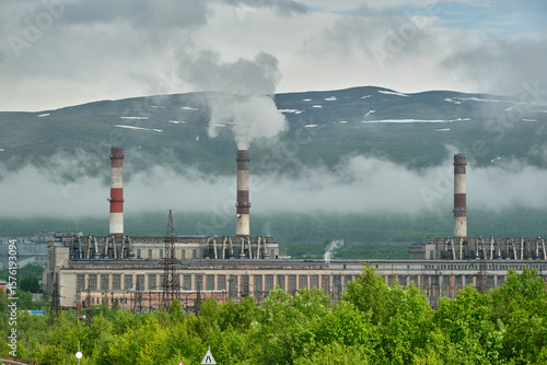 
smoke from the chimney in the photo of the mountains