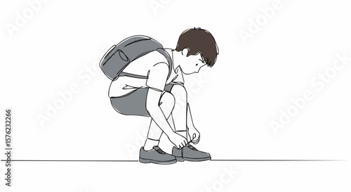 A schoolboy tying his shoelaces before school.