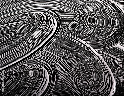 soap foam waves wipe marks on glass close up black and white background
