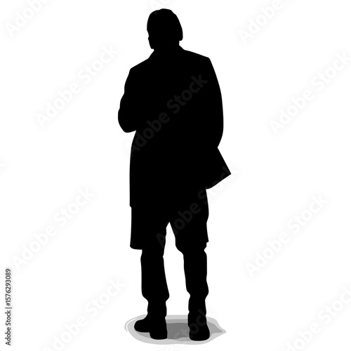 Silhouette of man standing and thinking with hands in pockets  