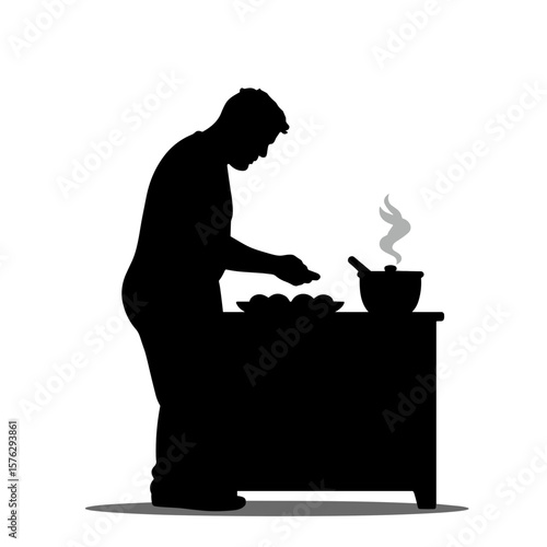 Man cooking in kitchen silhouette at stove preparing meal  