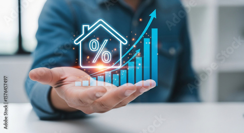 A businessman is holding a digital house icon with a rising graph, representing real estate investment and increasing mortgage interest rates