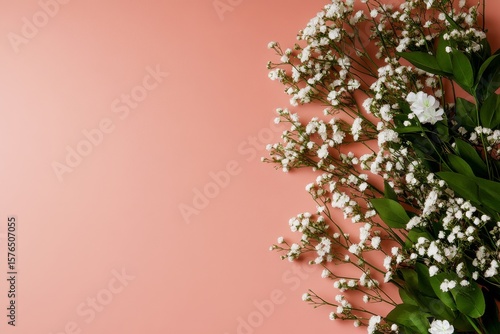 Beautiful White Blossoms With Green Leaves on Soft Pink Background During Spr...