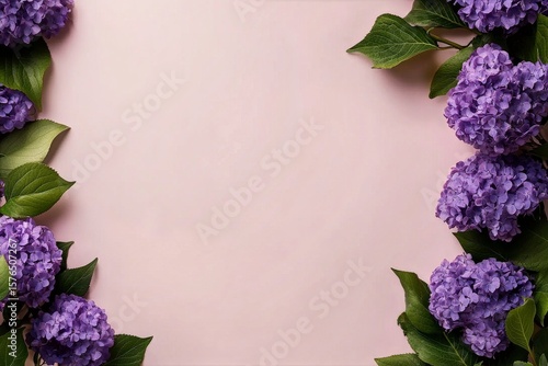 Purple Flowers Frame a Soft Pink Background With Greenery for a Vibrant and A...