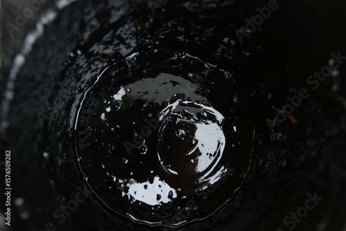 Bubbles forming at the bottom of a glass as water drains away during a warm afternoon in a cozy cafe