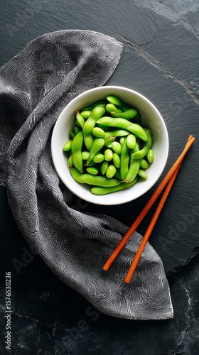 Fresh Edamame Served in a White Bowl With Chopsticks on a Dark Slate Surface ...