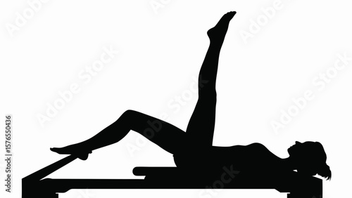 Silhouette of woman doing pilates reformer exercise with leg extended upward in a studio setting created with generated ai