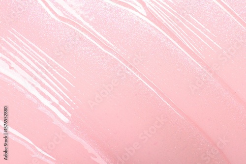 Tablou pe pânză Sample of clear lip gloss on pink background, top view