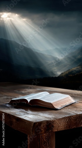 Light Rays Illuminate an Open Book on a Wooden Table Near Mountains at Sunset