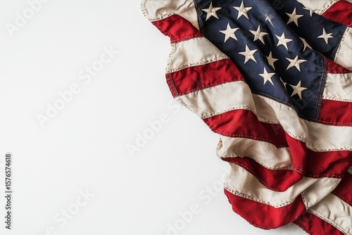 American Flag Draped in Soft Fabric Against a Plain Background Showcasing Pat...