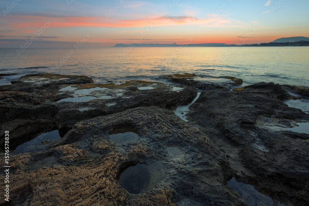 Naklejka premium Sunset tropical landscape. Summer sea on the stone beach. Wallpaper background. Natural scenery. Romantic relax place. Touristic resort Antalya, Turkey