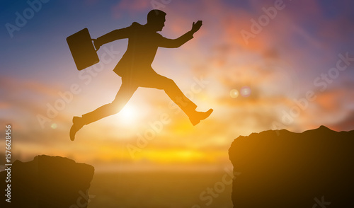 Silhouette of a business with his pocket jump up to another side