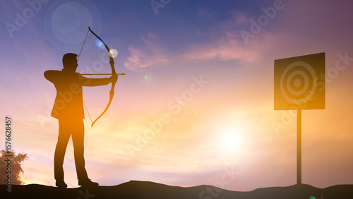 Silhouette of a business man shooting target by archer