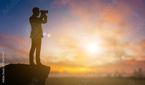 Business man explore by telescope on the mountain