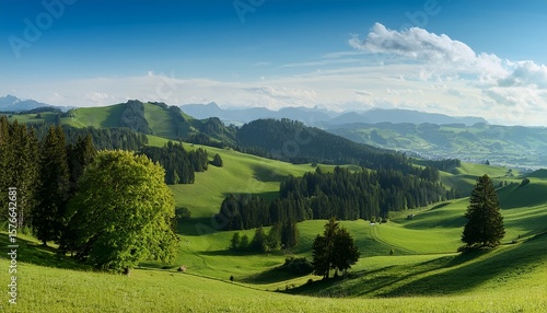 Wallpaper Mural vast green landscape with rolling hills scattered trees distant mountains and a peaceful atmosphere in the swiss jura Torontodigital.ca