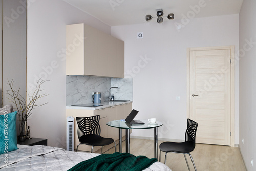 This modern studio apartment includes a kitchenette and a dining area for your comfort