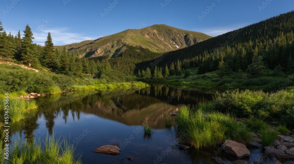 Obraz premium Serene mountain lake nestled in a valley.