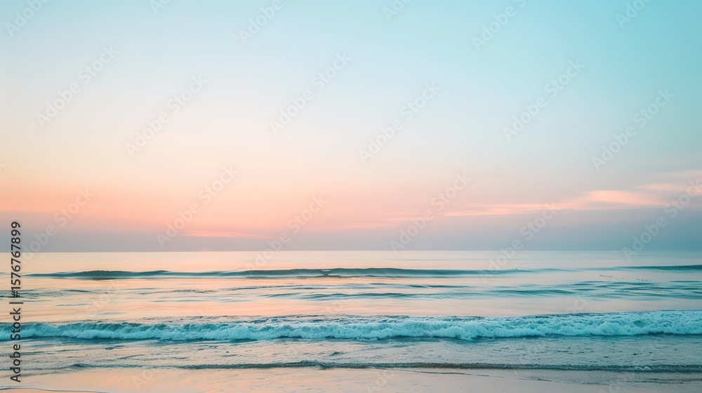 Fototapeta premium Soft pastel sunset painting the sky over a calm ocean beach, with gentle waves lapping the shore. The sky blends hues of pink, blue, and purple, while the water mirrors the serene colors, 
