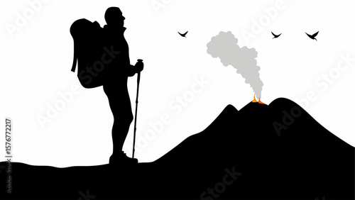 Silhouette of hiker with backpack and pole looking at erupting volcano with birds in the sky above it