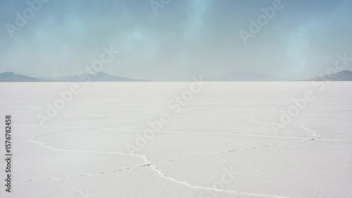 Expansive salt flat landscape under a clear blue sky