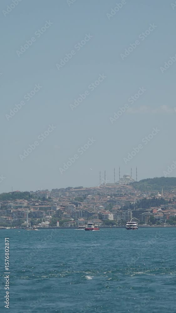 istanbul cityscape along the shore as boats navigate the water istanbul cityscape along the shore as boats navigate the water