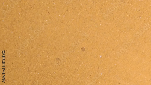 Background of brown kraft paper or cardboard texture. Abstract pattern of beige rough carton, old paper sheet, parchment or papyrus surface.