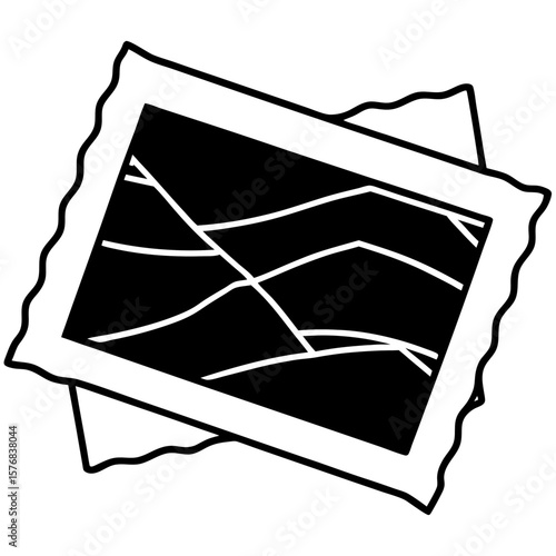 Torn photograph with white cracks in dark background