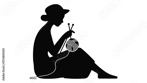 Silhouette of a woman wearing a hat knitting with yarn and needles