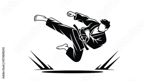 Karate fighter in mid air performing a powerful jumping kick with a clenched fist