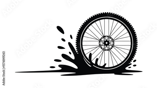 Black silhouette of a bicycle wheel splashing through water or mud