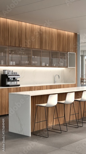 Modern office kitchenette with wood cabinetry, white quartz countertop, and sleek bar stools.  The space is bright and minimalist
