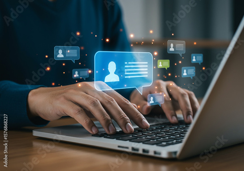 Person typing on laptop with glowing chat message icons